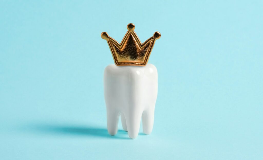 Golden dental crown on a tooth model highlighting advanced crown technology at Northside Family Dentistry