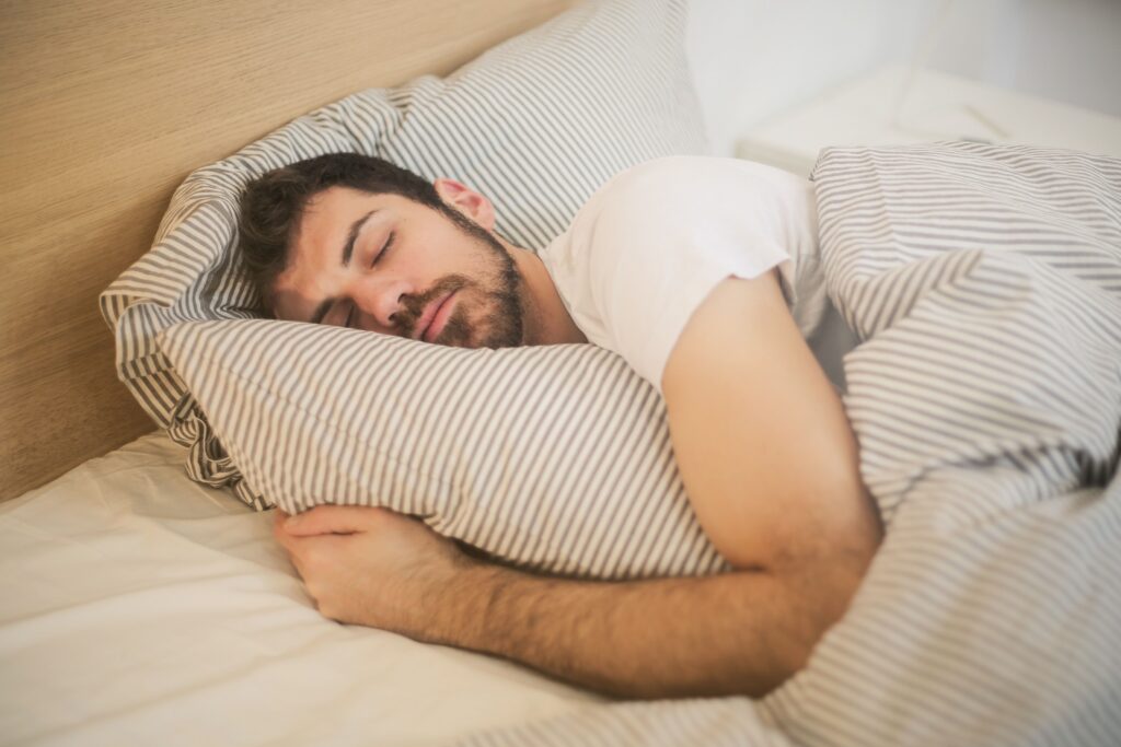 Person sleeping peacefully, representing nighttime teeth grinding and sleep-related oral health concerns.